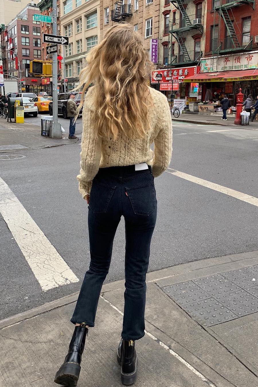 cable knit sweater with jeans and combat boots