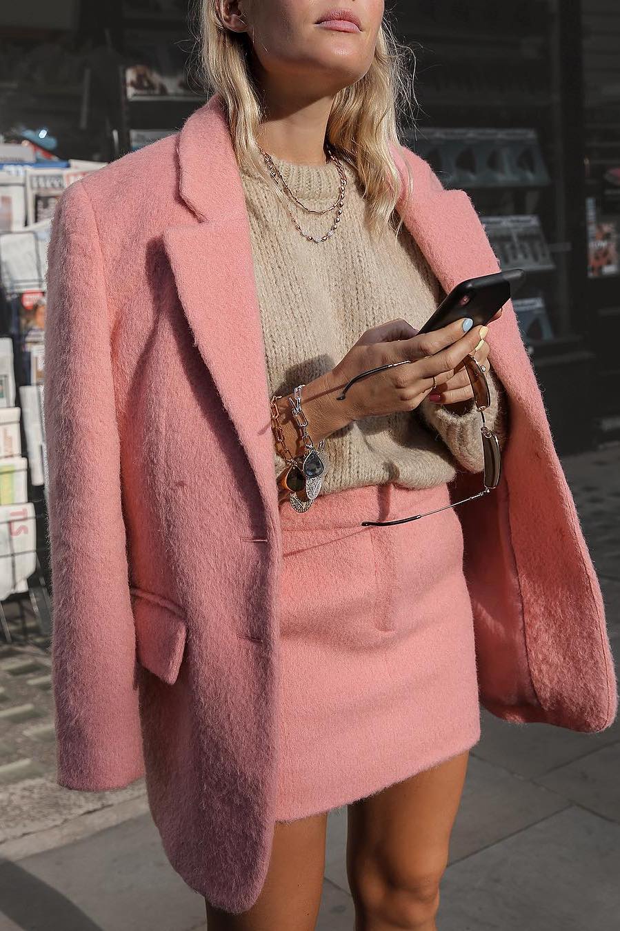 pink oversized blazer with pink skirt and a beige sweater