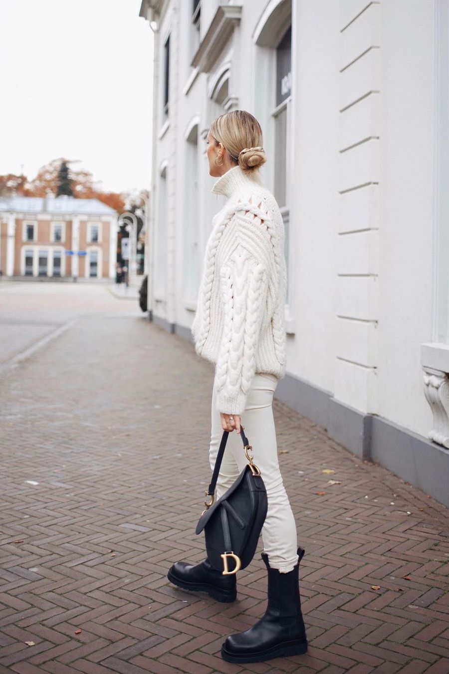 white cable-knit sweater with white jeans